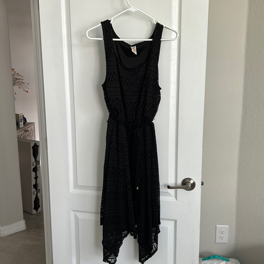 Knee length handkerchief bottom black dress with suede braided belt